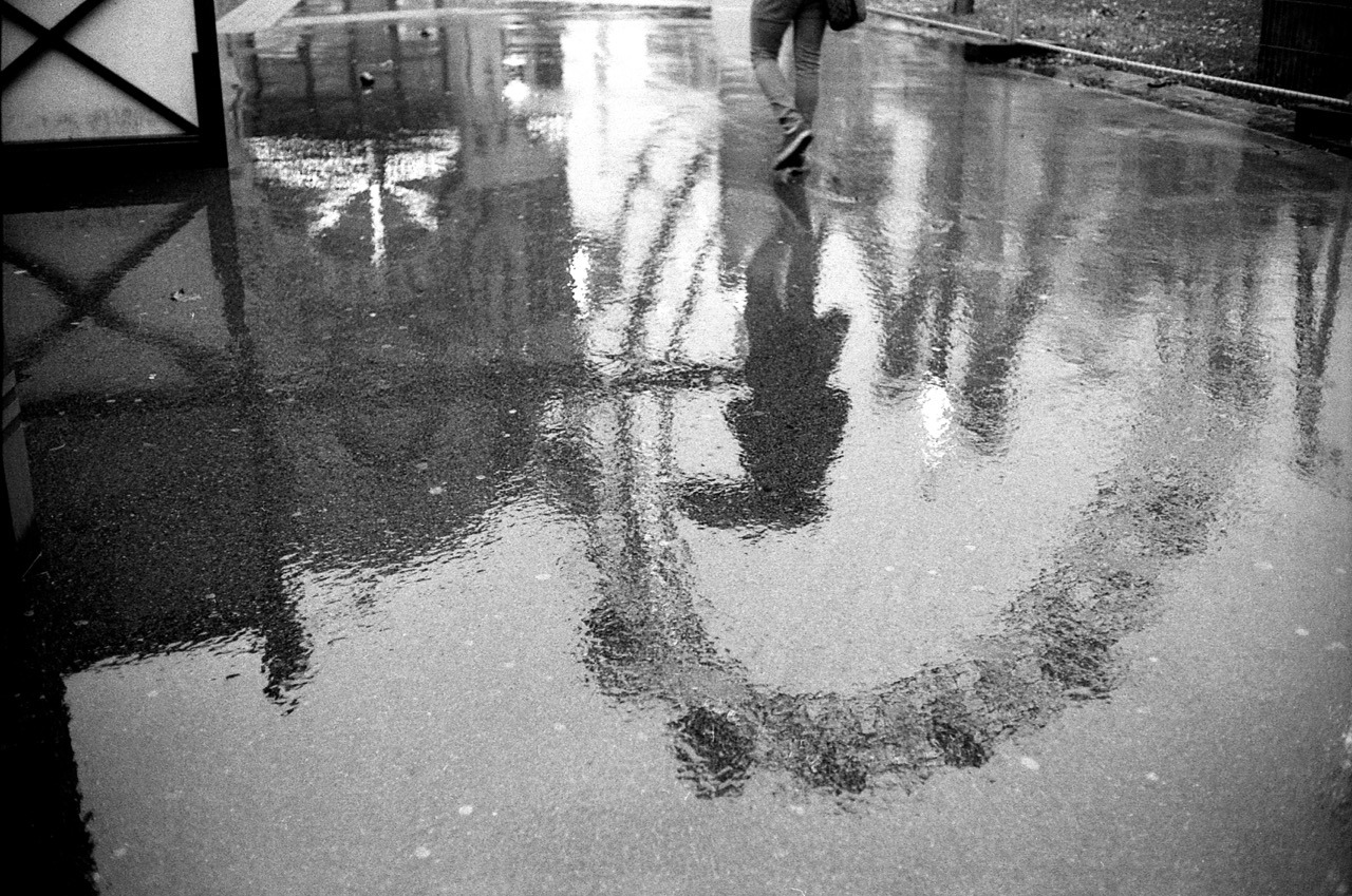 334/365: My last day in Vienna. One last coffee with Severin, who handed me my prints and a copy of his Vienna mag.
Went to the Prater in the afternoon. It was not really enjoyable weather. At least it made for a good rainy-day reflection photo. And...