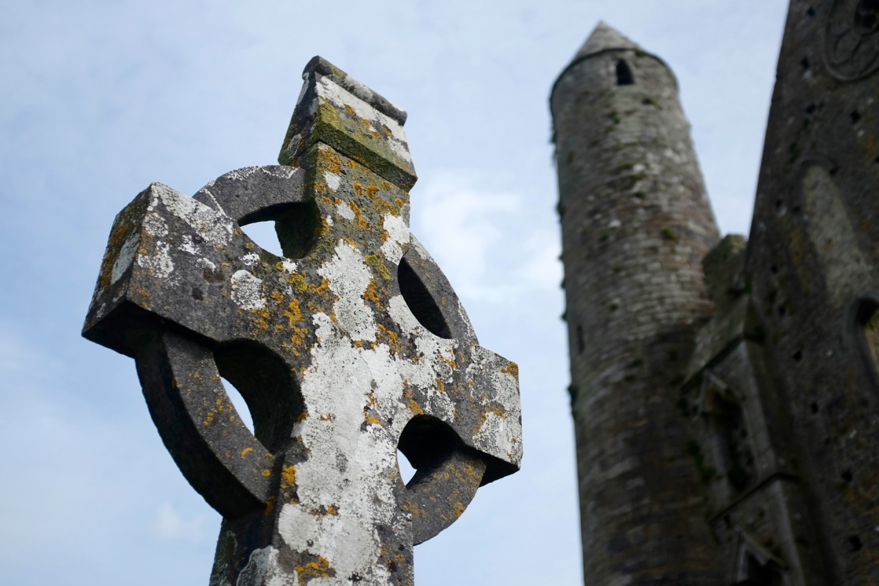 213/365: A celtic cross and the Round Tower at the Rock of Cashel.